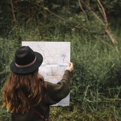 woman-looking-map-nature